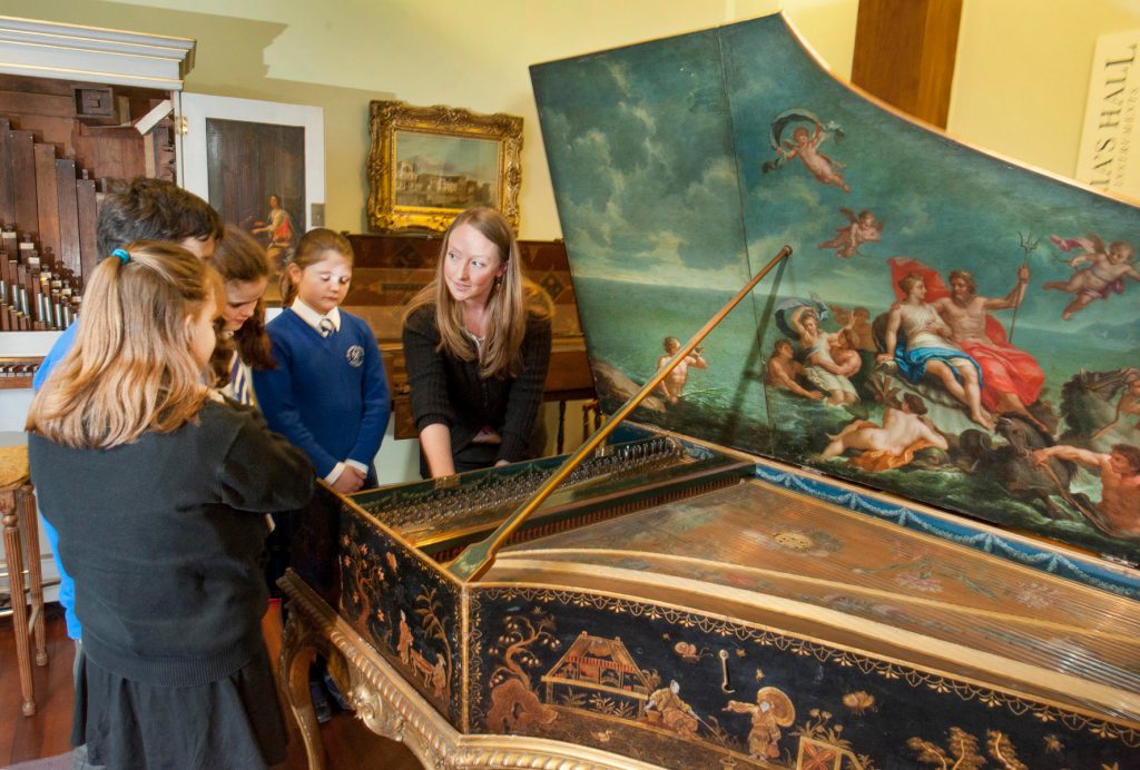 One of the St Cecilia's Team explaining how a Harpsichord works on one of our school tours