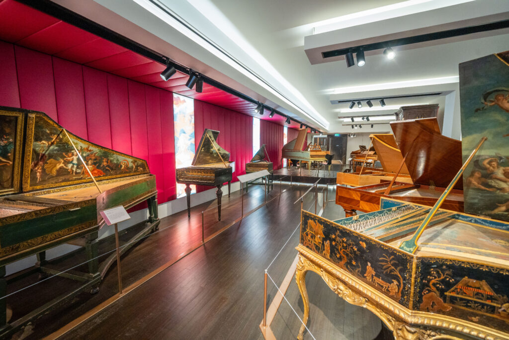A gallery at St Cecilia's Hall full of historic keyboard instruments